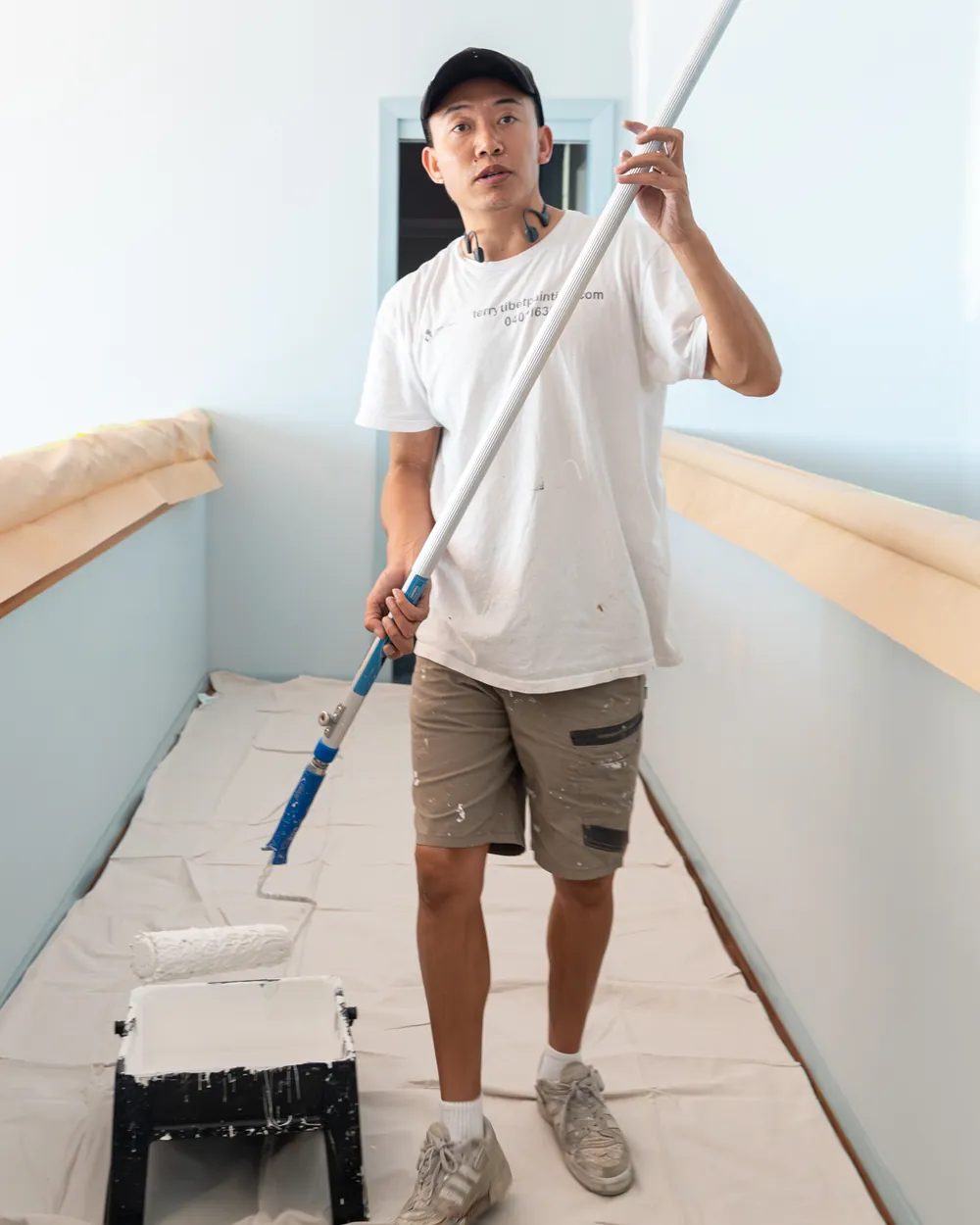 Terry Tibet Painting painter rolling a fresh ceiling coat on a Central Coast home